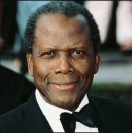 Headshot of a smiling older man wearing a tuxedo and bow-tie